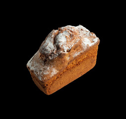 Whole homemade cupcake sprinkled with powdered sugar on black isolated background. National dish