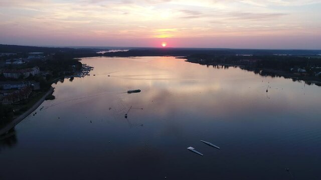 View of the lake during the sunset. City buildings in the foreground.