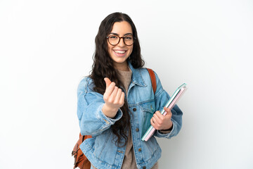 Young student woman isolated on white background making money gesture