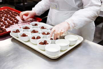 Female chef is portioning airline desserts, toned