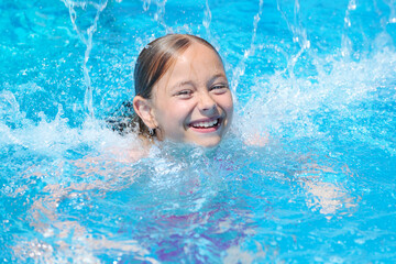 Fototapeta na wymiar Little girl swimming at the pool