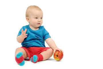 Baby boy with an apple on white background