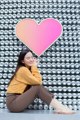 Asian beautiful woman with long hair is sitting and closing her eyes in heart background as Valentine’s  day concept. abstract background