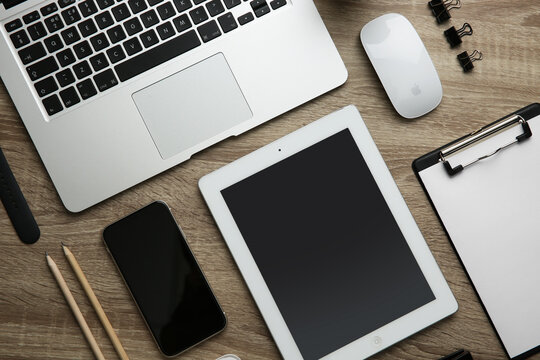 MYKOLAIV, UKRAINE - JULY 20, 2020: Flat lay composition with iPhone 11 and different Apple gadgets on wooden table