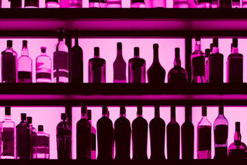 Rows of bottles sitting on shelf in a bar