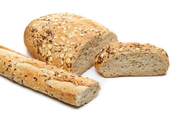 Integral wheat bread and french baguette, sliced loaves with seeds (linseed, oats) isolated on white background