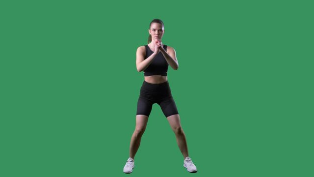 Aerobic female trainer doing step touch lateral side to side exercise. Full body on chroma key green screen. 