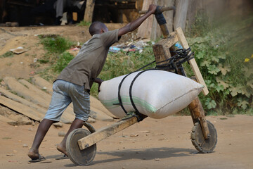 person working with a cart handmade in africa road - obrazy, fototapety, plakaty