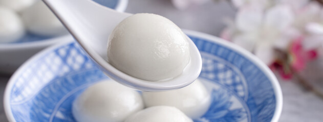 Close up of yuanxiao tangyuan in a bowl on gray table, food for Chinese Lantern Yuanxiao Festival.