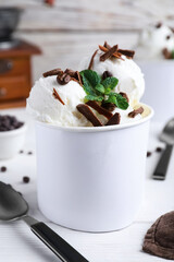 Yummy ice cream with chocolate served on white table