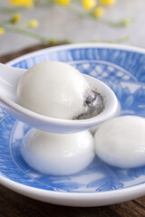 Close up of yuanxiao tangyuan in a bowl on gray table, food for Chinese Lantern Yuanxiao Festival.