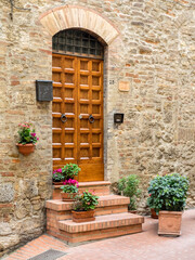 Fototapeta na wymiar Europe, Italy, Chianti. Doorway to a home decorated with potted plants on the steps.