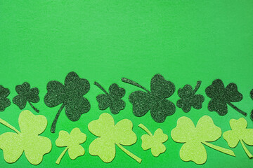 Flat lay composition with clover leaves on light green background, space for text. St. Patrick's...