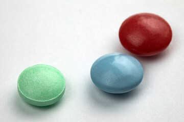 Multicolored tablets on white background. Health care concept.