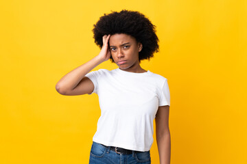 Young African American woman isolated on yellow background with an expression of frustration and not understanding