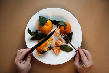 plate with tangerines and hands