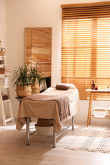 Stylish massage room interior in spa salon