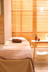Stylish massage room interior in spa salon