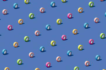 Isometric pattern made of colourful duct tape arranged on blue background. Minimal concept. Creative wallpaper.
