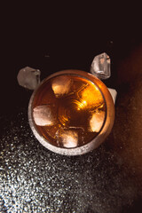 A glass of cognac on a dark background.
