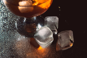 A glass of cognac on a dark background.