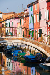 Fototapeta na wymiar Italy, Burano. Reflection of colorful houses in canal.