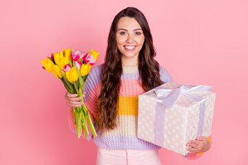 Obraz na płótnie Canvas Portrait of attractive cheerful girl holding in hands tulips giftbox festal event congrats isolated over pink pastel color background