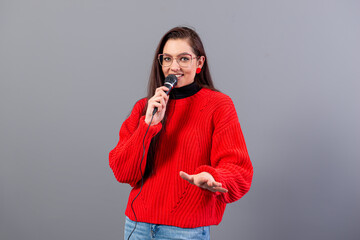 female conference speaker dressed in a red sweater during presentation calling for attention, isolated