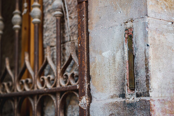 Mezuzah built into the wall at the corner of the stone passage to the inside. Metal gates on the passage to the courtyard. Jewish symbols (252)