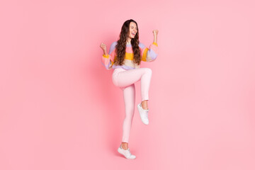 Fototapeta na wymiar Full length body size view of attractive overjoyed cheerful girl celebrating having fun triumph isolated over pink pastel color background