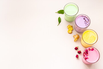 Multicolored lattes tea or coffee. Blue, yellow green and pink latte top view