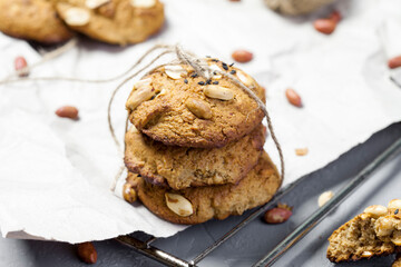 Peanut butter chocolate chip cookies stacked up on a table