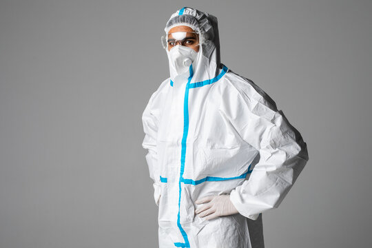 Portrait Of Man Doctor Wearing Googles, Protective Glasses In Protection Suit, Face Surgical Mask On White Background. Concept Of Medicine Health Care Covid 19 Coronavirus Pandemic Epidemic Quarantine