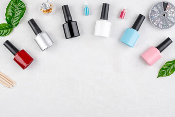 Obraz na płótnie Canvas Colorful bottles of nail polishes and accessories for manicure and pedicure on a white background. Copy space