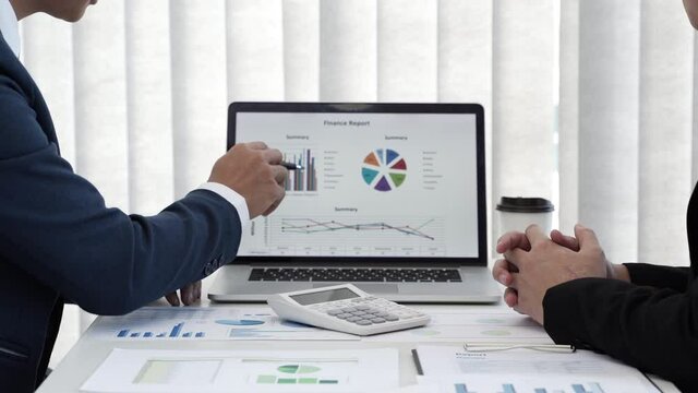 Group of businessmen is discussing in the office about the company profit figures.
