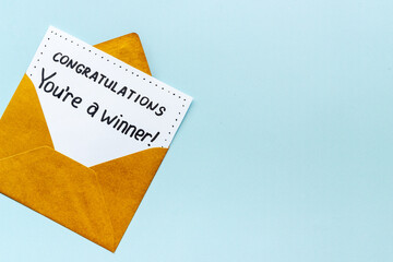 Golden envelope with award card Congratulations You are a winner. Overhead view
