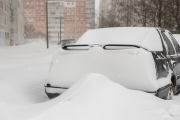 Blocked cars after heavy snow storm.Covered by snow cars after heavy snowfall at the parking in the city