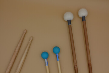 Percussion mallets set on a cream background.