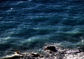Blue ocean waves and rocks - high angle view