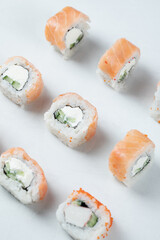 Salmon rolls with cream cheese on a white background
