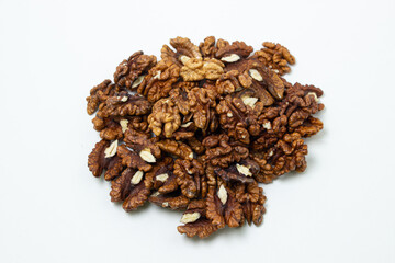 Peeled walnuts on a white background. A bunch of shelled walnuts. Nutritious food