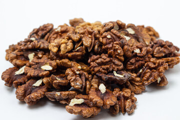 Peeled walnuts on a white background. A bunch of shelled walnuts. Nutritious food