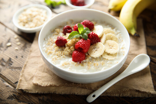 Healthy oatmeal porridge with fresh raspberry and banana