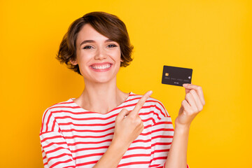 Photo of young attractive pretty cheerful positive smiling girl recommending credit card isolated...