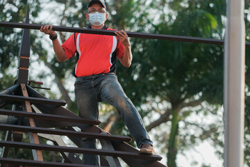 Carpenter making installation of roof structure  on a new gazebo construction project