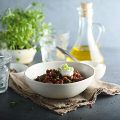 Homemade beef chili con carne with sour cream