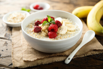 Healthy oatmeal porridge with fresh raspberry and banana