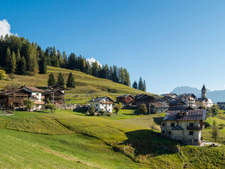 Fototapeta na wymiar Village Sappade, traditional alpine architecture in valley Val Biois, Italy.