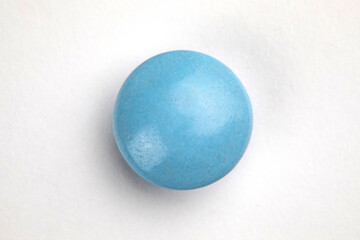 Blue round pill on white background. Health care concept.