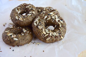 Vegan gluten free bagels topped with sunflower seeds, flax seeds and sesame seeds. Healthy breakfast food. 